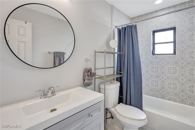 full bathroom featuring shower / bath combo, vanity, and toilet