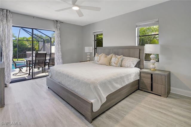 bedroom featuring access to exterior, multiple windows, and light wood-style flooring