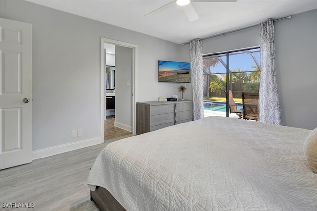 bedroom featuring wood finished floors, a sunroom, baseboards, a ceiling fan, and access to exterior