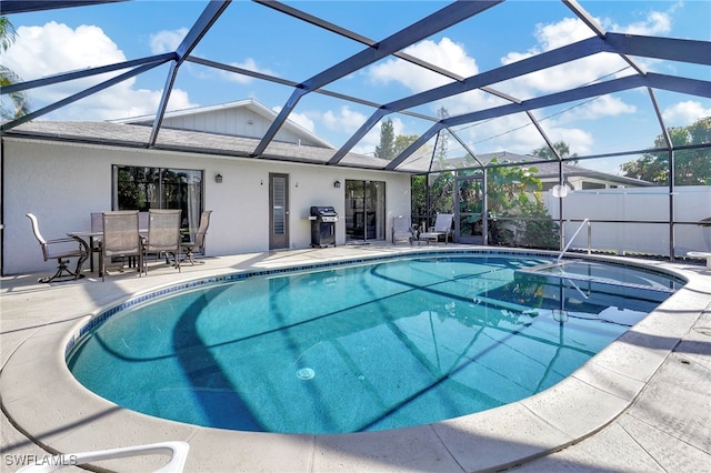 view of swimming pool featuring a patio, grilling area, a lanai, and a fenced in pool