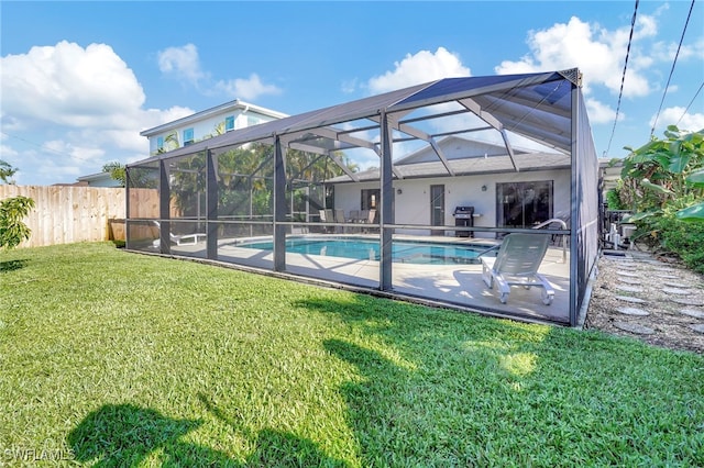 view of pool featuring a fenced in pool, a patio, a lawn, glass enclosure, and fence