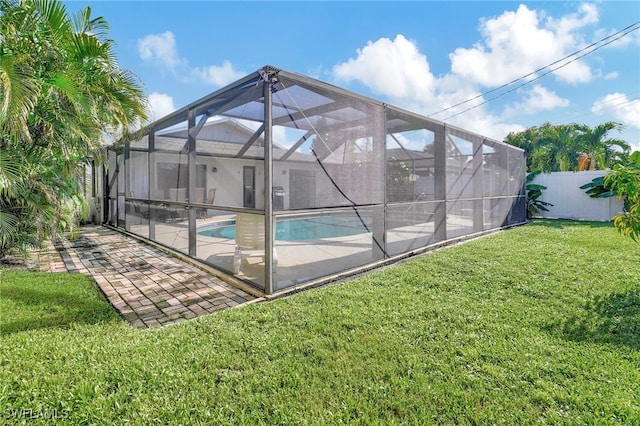 view of pool with a fenced in pool, a lawn, a lanai, fence, and a patio area