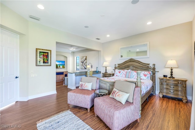 bedroom with dark hardwood / wood-style floors