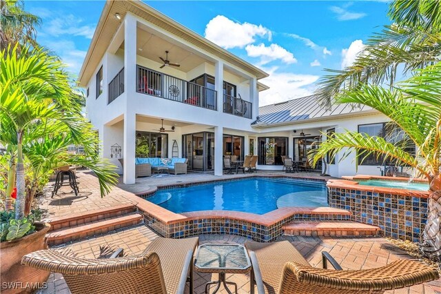 view of swimming pool featuring ceiling fan, a patio, an in ground hot tub, and outdoor lounge area