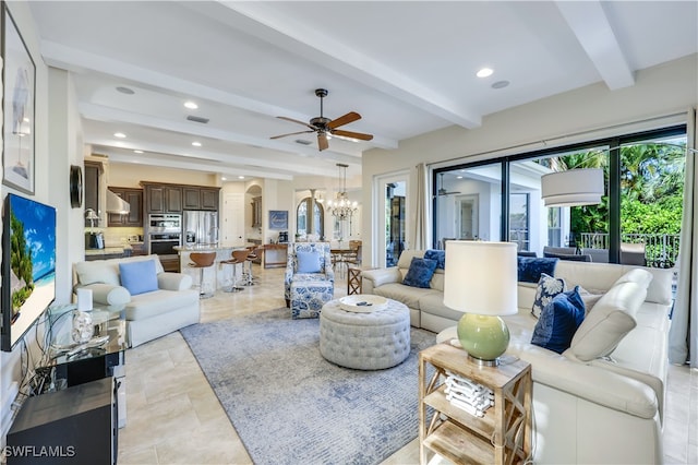 tiled living room with beam ceiling and ceiling fan with notable chandelier