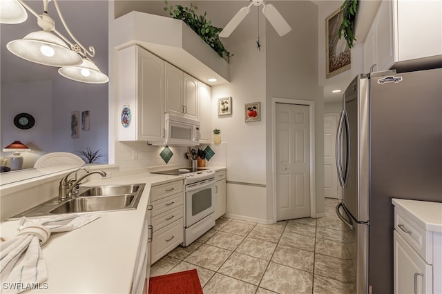 kitchen featuring white appliances, high vaulted ceiling, sink, ceiling fan, and white cabinetry