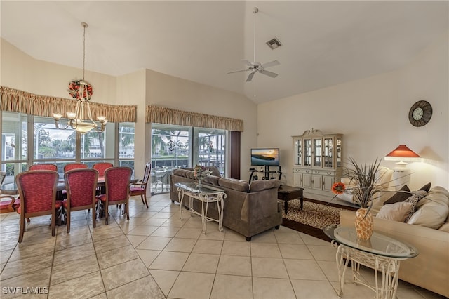 living room with light tile patterned floors, high vaulted ceiling, and ceiling fan with notable chandelier