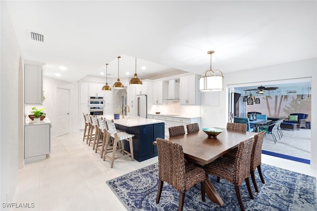 dining space with ceiling fan and light tile patterned floors