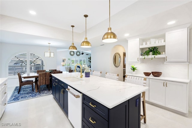 kitchen featuring white cabinets, sink, dishwasher, and pendant lighting