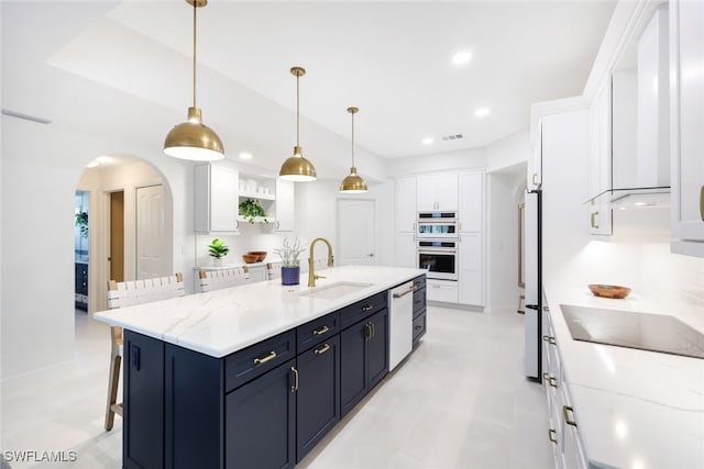 kitchen featuring light tile patterned flooring, white cabinets, sink, and dishwashing machine