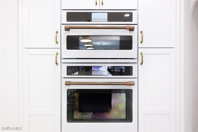 kitchen with white cabinetry and white double oven