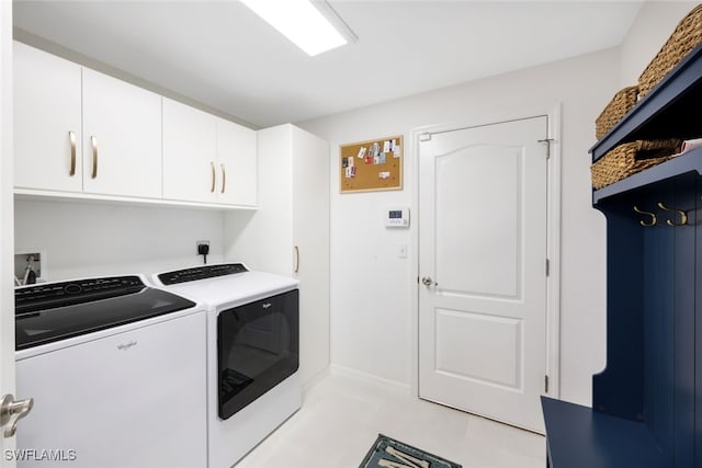 laundry area with independent washer and dryer and cabinets