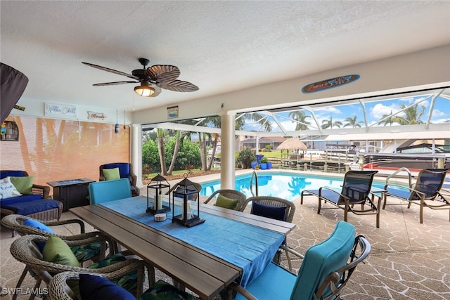 view of patio with ceiling fan and a lanai