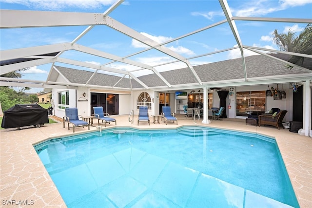 view of swimming pool with area for grilling, a lanai, a patio, and outdoor lounge area