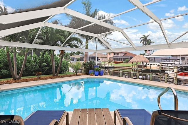 view of pool with a lanai and a water view