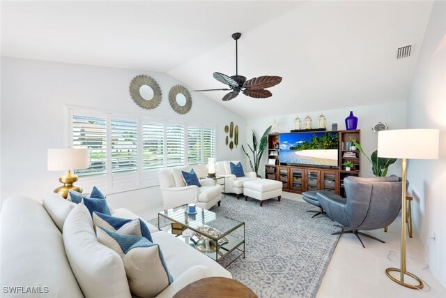 living room featuring ceiling fan, vaulted ceiling, and light tile patterned floors