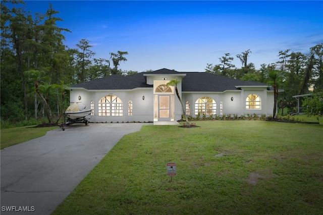 ranch-style house featuring a yard