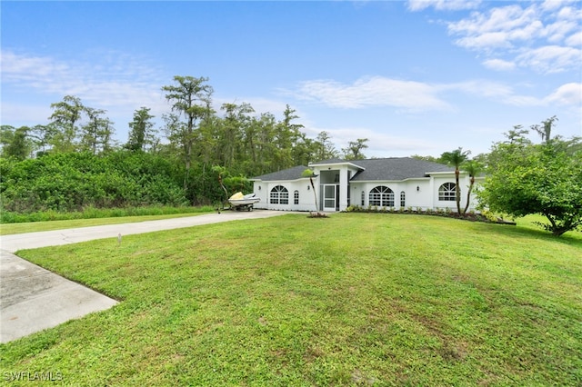 ranch-style home featuring a front yard