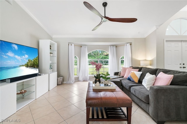 tiled living room with ceiling fan and crown molding