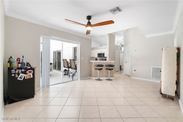 living room featuring ceiling fan, light tile patterned floors, and ornamental molding