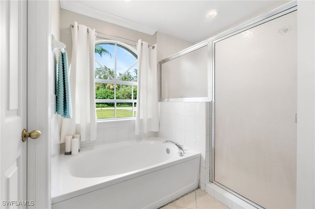 bathroom featuring independent shower and bath, crown molding, and tile patterned flooring