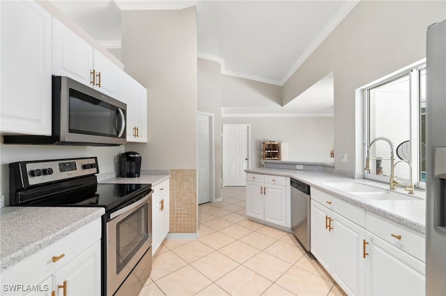 kitchen with white cabinets, light tile patterned floors, stainless steel appliances, ornamental molding, and sink