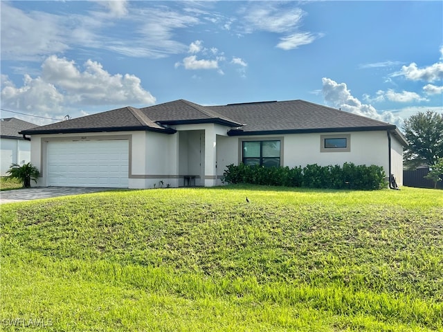 view of front of house with a garage and a front lawn