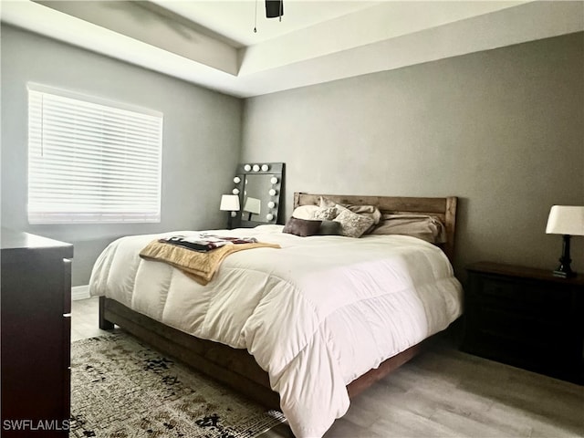 bedroom featuring wood-type flooring and ceiling fan