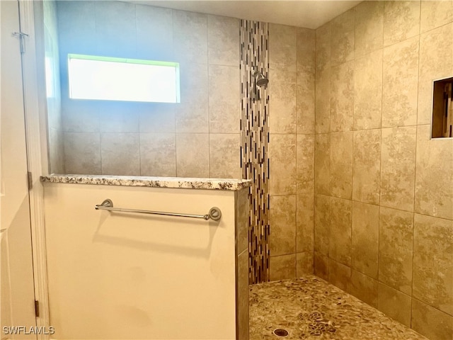 bathroom with a tile shower