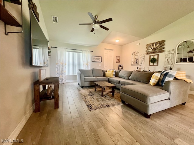 living room with lofted ceiling, ceiling fan, and light hardwood / wood-style floors