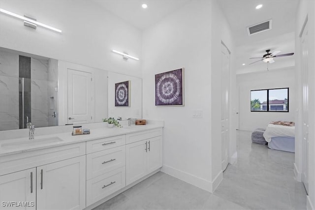 bathroom featuring vanity, ceiling fan, and a tile shower