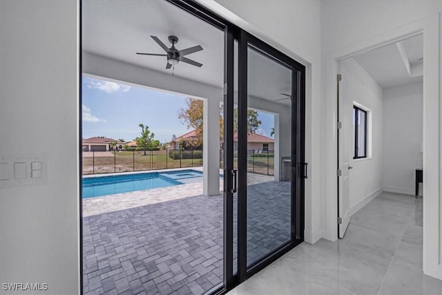 doorway with a wealth of natural light and ceiling fan