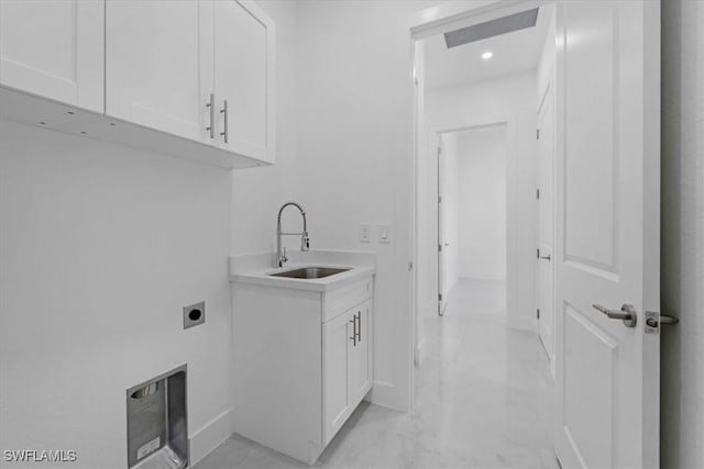 clothes washing area featuring cabinets, sink, heating unit, and electric dryer hookup