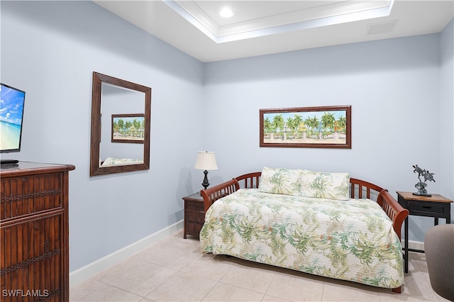 bedroom with a raised ceiling, light tile patterned floors, and ornamental molding