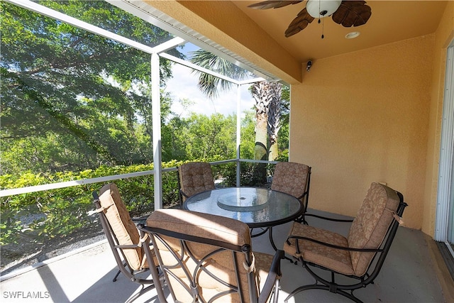 sunroom featuring ceiling fan