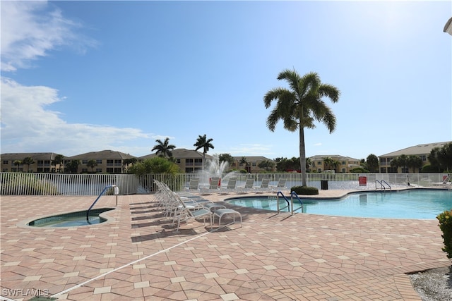 view of pool featuring a patio and a hot tub