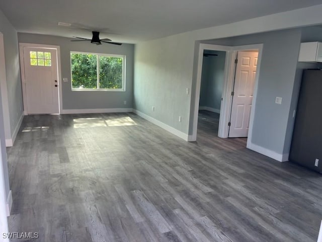 unfurnished living room featuring ceiling fan and hardwood / wood-style flooring