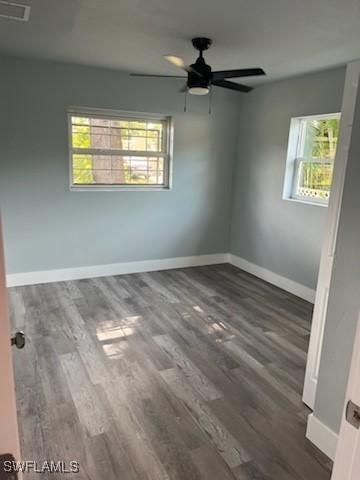 unfurnished room featuring dark hardwood / wood-style flooring and ceiling fan