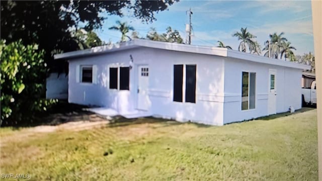 rear view of house with a yard