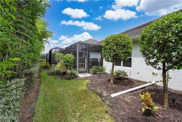 view of yard featuring glass enclosure