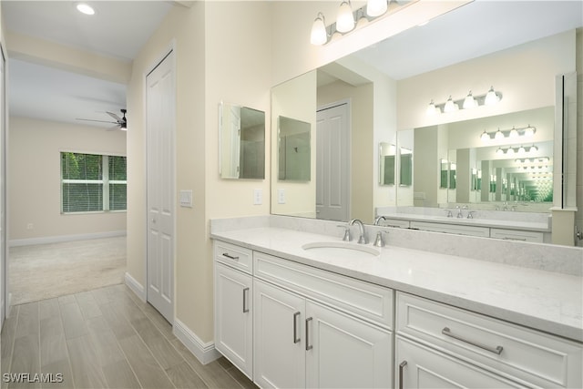 bathroom featuring ceiling fan, vanity, and electric panel