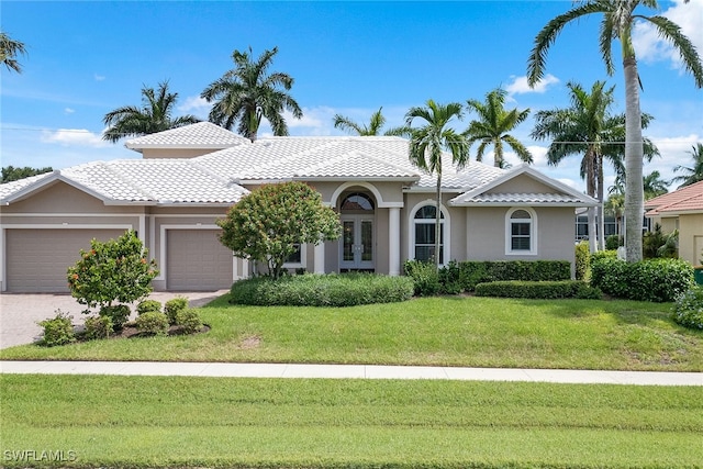 mediterranean / spanish-style house with a front lawn and a garage