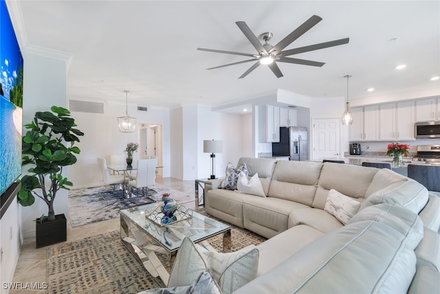 tiled living room featuring crown molding and ceiling fan with notable chandelier