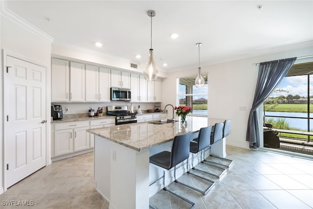 kitchen with appliances with stainless steel finishes, sink, white cabinets, light tile patterned flooring, and hanging light fixtures