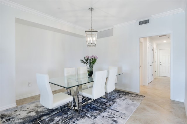 dining room featuring tile patterned floors, an inviting chandelier, and crown molding