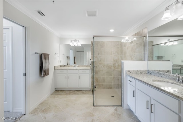 bathroom featuring a shower with shower door, vanity, and tile patterned floors