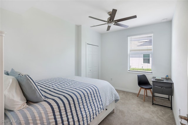 carpeted bedroom with ceiling fan and a closet