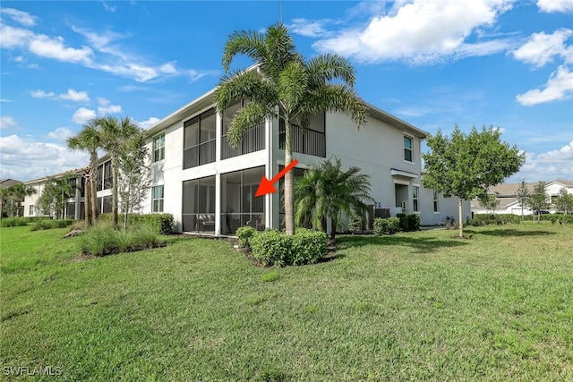 rear view of house featuring a yard