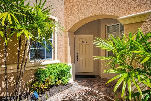 13921 Lake Mahogany Blvd Unit 2813, Fort Myers, FL 33907 - doorway to property with stucco siding