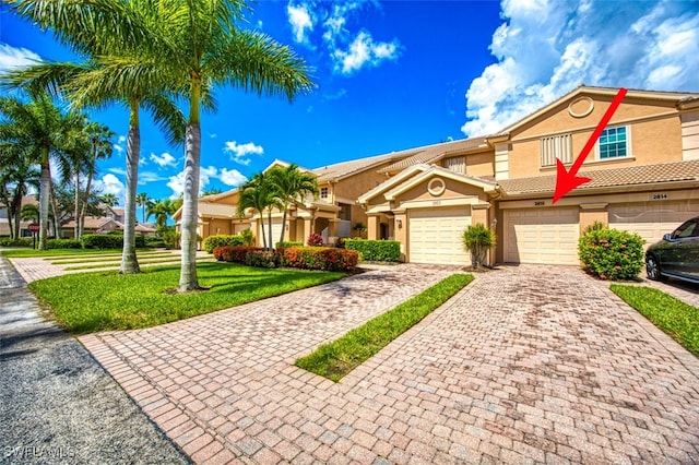 view of front of home with a garage and a front yard